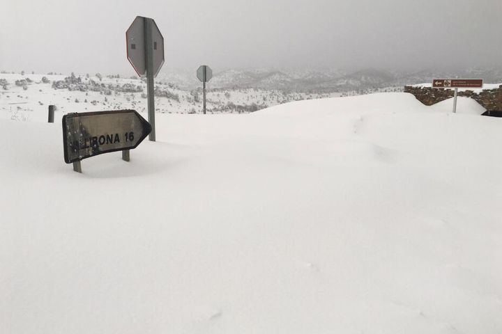 Ein Schild, das die Distanz zum Dorf Vallibona anzeigt, ist fast komplett mit Schnee bedeckt.