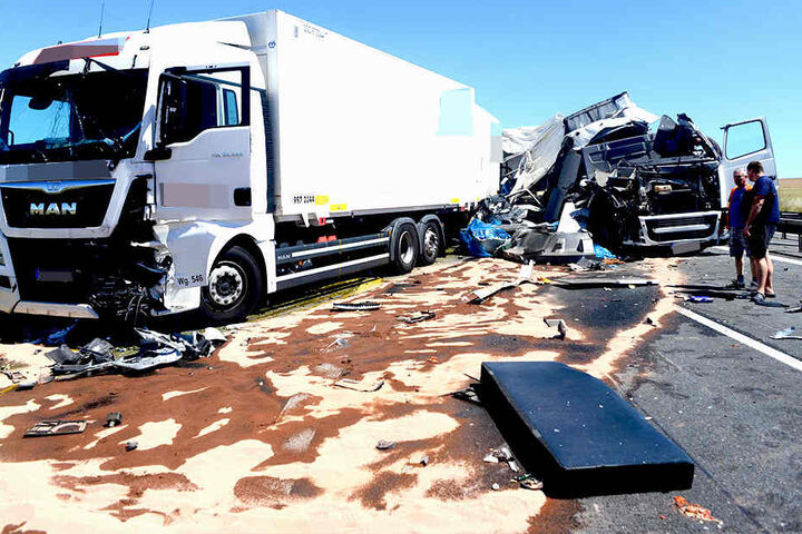 Das Lkw-Führerhaus (rechts) ist Schrott. Wrackteile liegen auf der Fahrbahn.