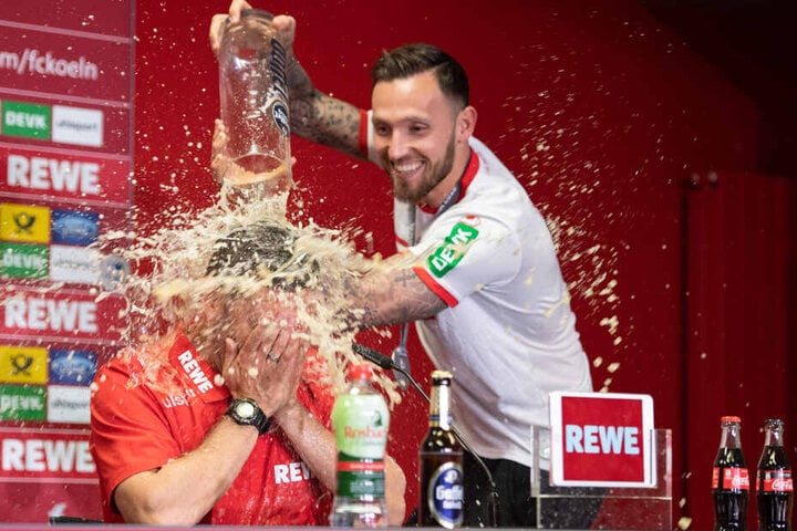 Kölns Marco Höger verpasst Interimstrainer Andre Pawlak während der Pressekonferenz eine Bierdusche.