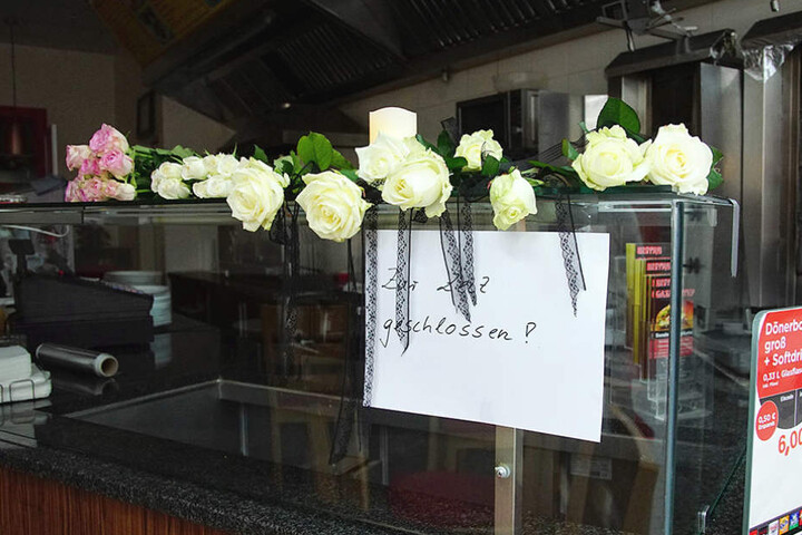 Passanten haben Rosen als Zeichen ihrer Anteilnahme niedergelegt.