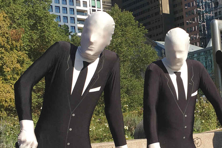 Aktivisten verkleideten sich als gesichtslose Banker- oder Manager-Gestalten.