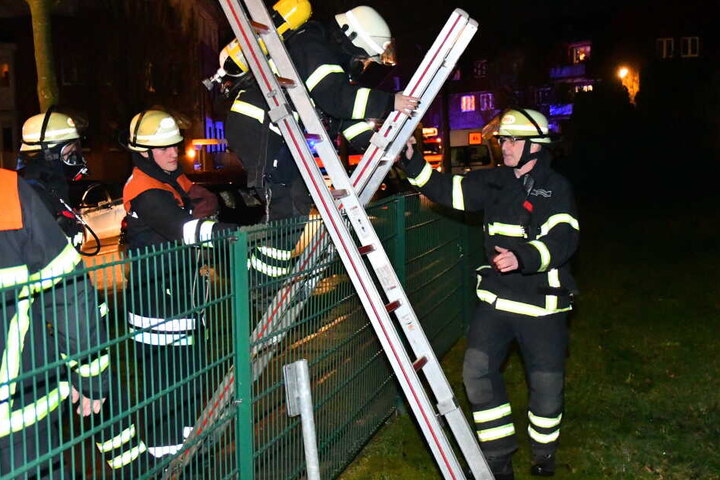 Die Feuerwehrleute mussten über einen Zaun klettern, um das Feuer zu erreichen.