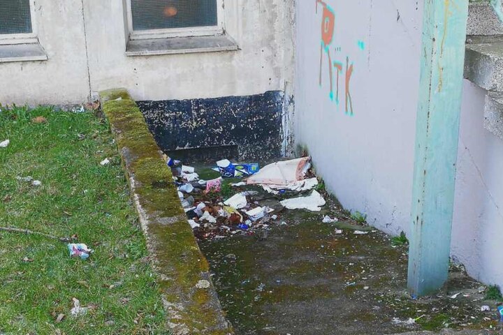 Müll liegt neben dem Eingangsbereich zur 84. Schule.