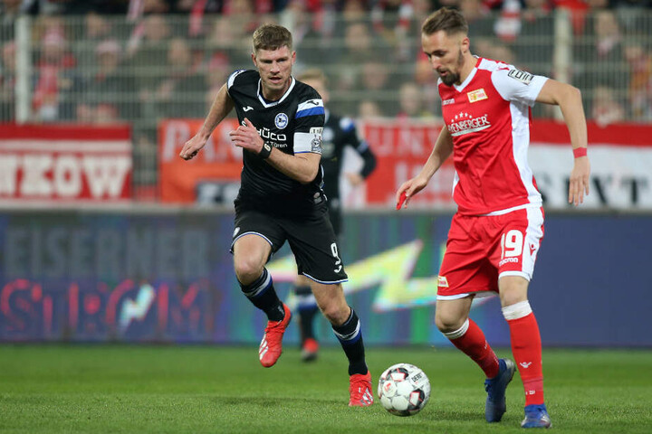 Fabian Klos von Arminia Bielefeld (l) und Berlins Florian Hübner kämpfen um den Ball.