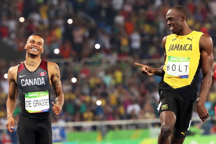 André De Grasse und Usain Bolt zogen locker ins Finale ein.