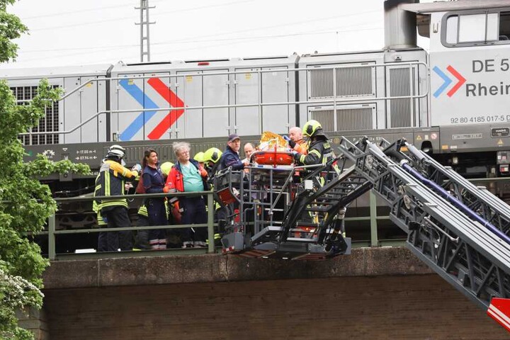 Rettungskräfte bei der Bergung des Tatverdächtigen an einer Bahnstrecke.
