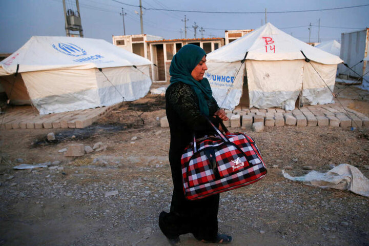 Eine syrische Frau, die durch die türkische Militäroperation im Nordosten Syriens vertrieben wurde, läuft mit einer Tasche in der Hand durch das Lager Bardarash, nördlich von Mosul. Vor der türkischen Militäroffensive sind nach Angaben der UN-Organisation