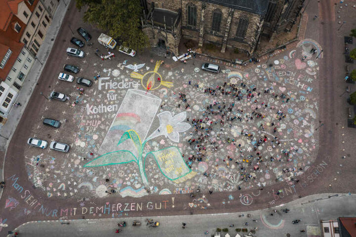 "Man sieht nur mit dem Herzen gut", "Frieden für Köthen" und "Bunt ist schön" sind einige Sprüche, die Einwohner auf ihren Marktplatz gemalt haben.