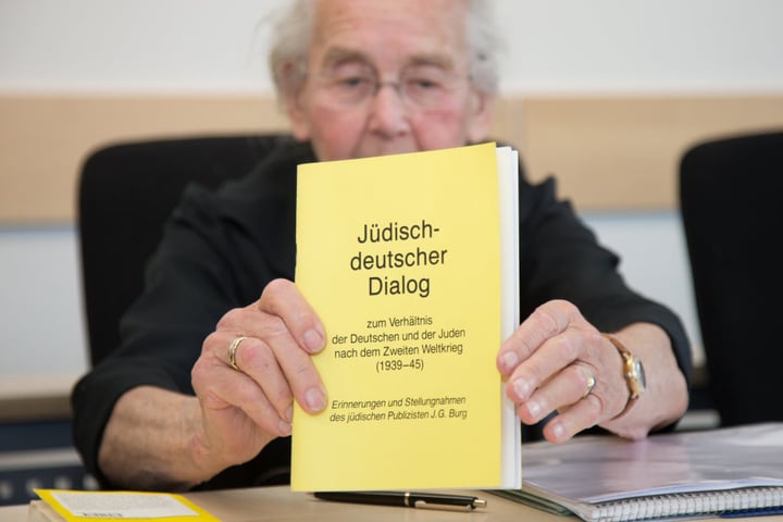 Die Angeklagte Ursula Haverbeck hält im September vor gericht ein Buch mit dem Titel "Jüdisch-deutscher Dialog" in den Händen.