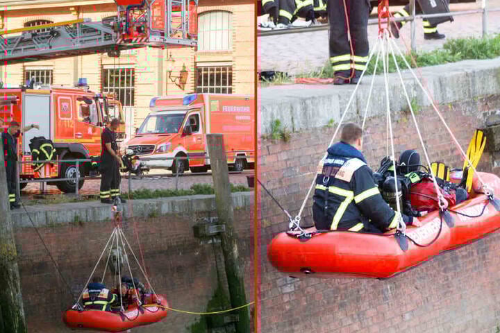 Die Feuerwehr lässt mithilfe eines Leiterwagens ein Rettungsboot mit Tauchern ins Wasser.