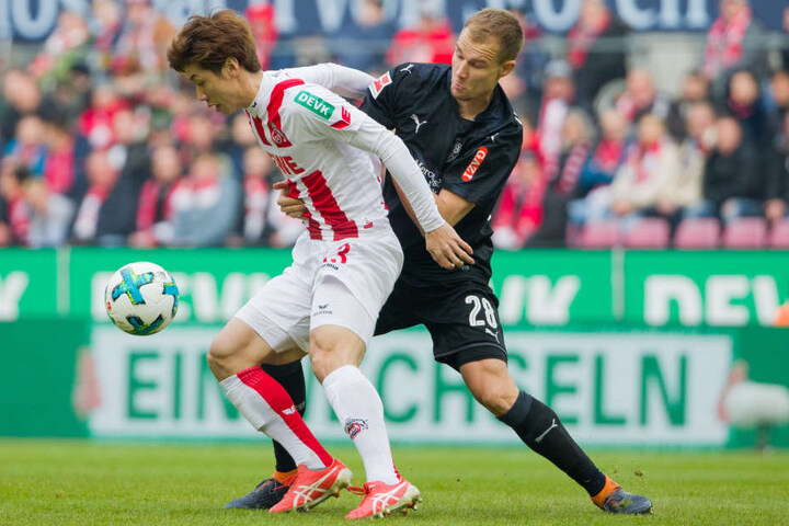 Kölns Yuya Osako (l.) und Stuttgarts Holger Badstuber versuchen an den Ball zu kommen.
