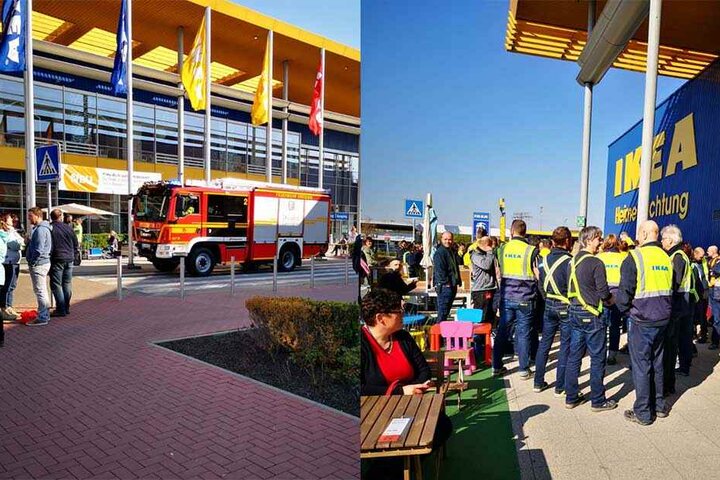 Eine Einsatzfahrzeug der Feuerwehr ist vor Ort (li.), während Mitarbeiter und Kunden vor dem Gebäude warten.