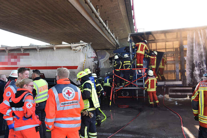 Einsatzkräfte befreien den eingeklemmten Lkw-Fahrer.
