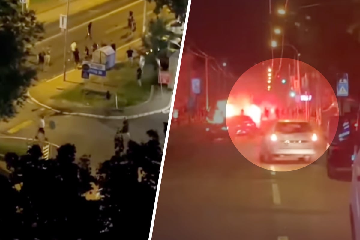 Hooligans prügeln sich auf offener Straße, Auto fährt in die Menge