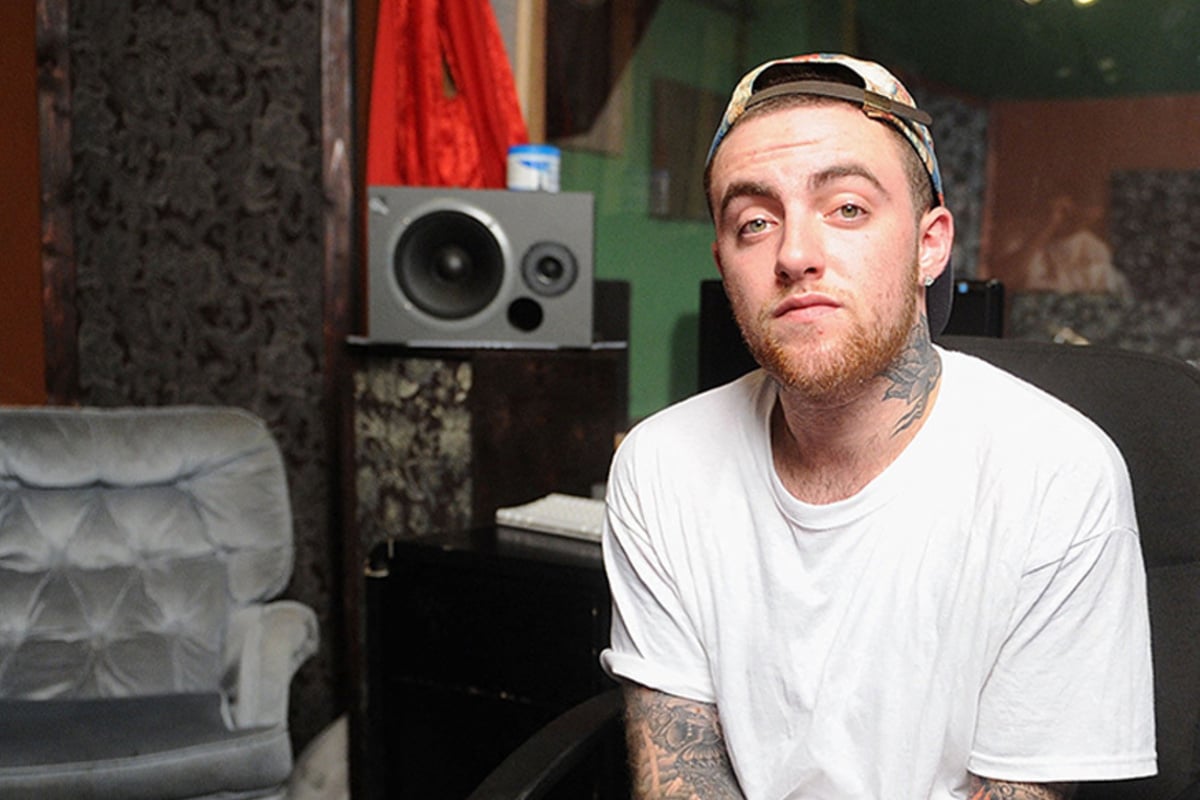 Mac Miller Is Having Tattoos In His Hand And Wearing White Shirt