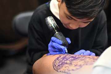 Nine-year-old tattoo artist makes his mark with expert work!