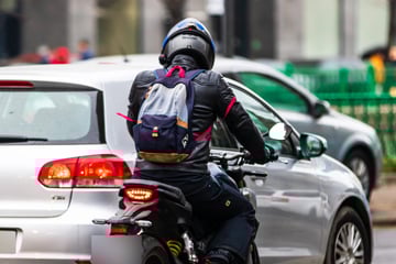 Biker schlägt während Fahrt Scheibe von Audi ein