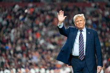 Trump greeted with boos and "You Lost" billboard at college football game
