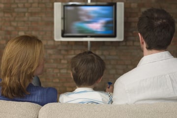 A family is sitting in front of the TV: suddenly something falls on them that leaves them speechless