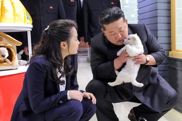 Kim Jong-un cuddles puppies and kittens on outing to North Korean pet shop