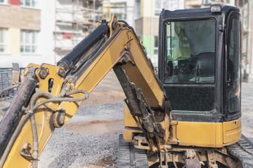 Mini-Bagger kippt um: Arbeiter eingeklemmt und schwer verletzt