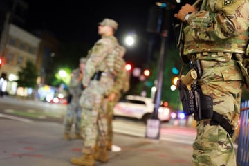 National Guard troops begin carrying weapons in Washington DC