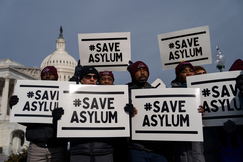 Activists hold signs during a news conference about the ongoing border negotiations outside of the US Capitol on Thursday.