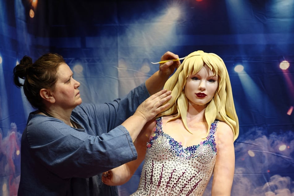 Cake artist Elza Baldzhiyska works on her creation of singer Taylor Swift after it was damaged in transit while being transported to the Cake International show at the NEC in Birmingham, central England on Friday.