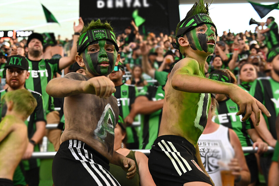 Young Austin FC fans cheer on the team from the supporters' section at Q2 Stadium in Austin, Texas.