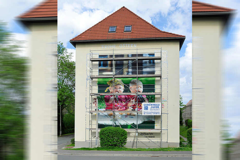 Zwei überdimensionale Zwillings-Babyköpfe zieren die Hauswand im Meeraner Nelkenweg.
