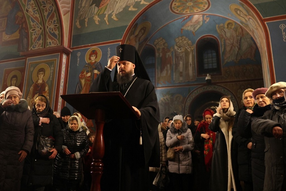 An Orthodox priest holds a Christmas service mass at the Saint Michael's Golden-Domed Monastery in Kyiv, Ukraine, on December 24, 2023.