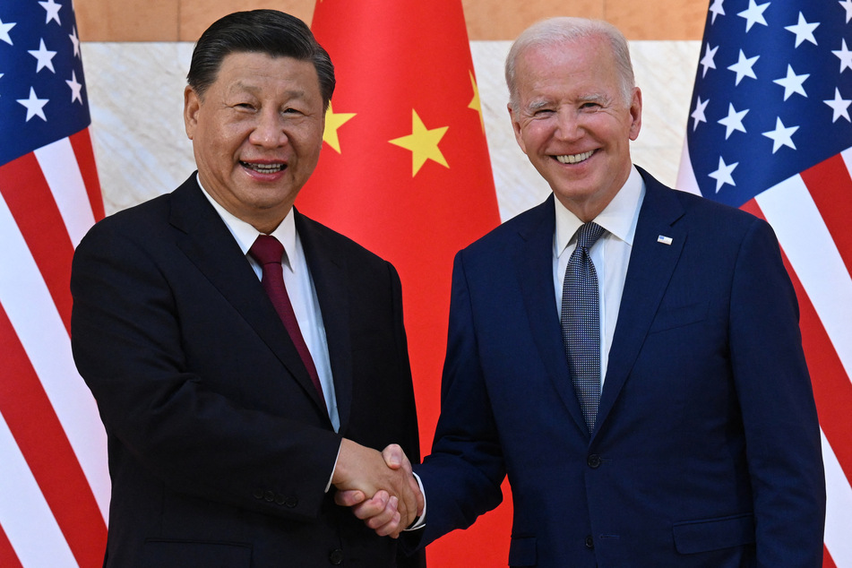 President Joe Biden (R) and China's President Xi Jinping (L) shake hands as they meet on the sidelines of the G20 Summit in Bali on November 14, 2022.