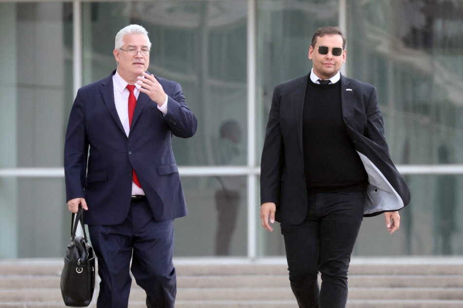 George Santos (r) appeared in New York federal court on Friday, where he pled not guilty to additional charges brought in a recent superseding indictment.