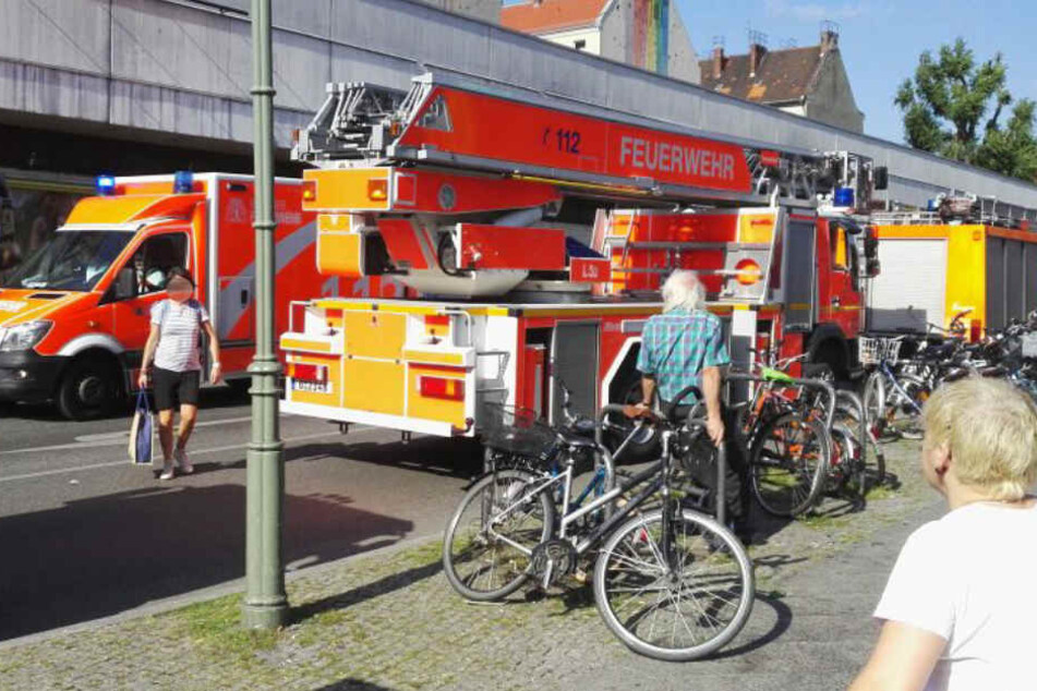 Vier Löschfahrzeuge der Feuerwehr sind am Freitagnachmittag am Bahnhof Neukölln vor Ort.