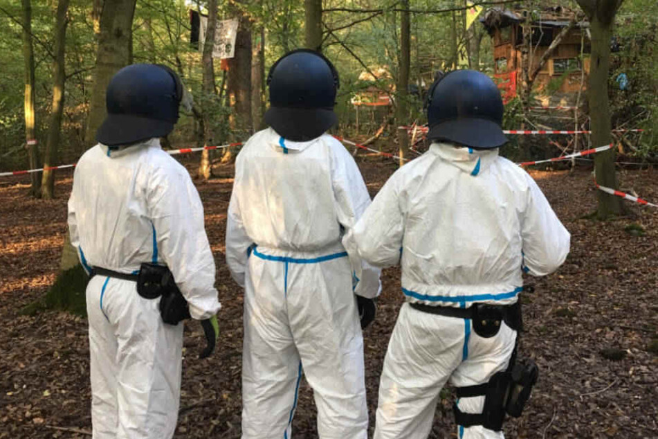 Die Polizisten haben Schutz-Anzüge wegen der Fäkal-Attacken angelegt.