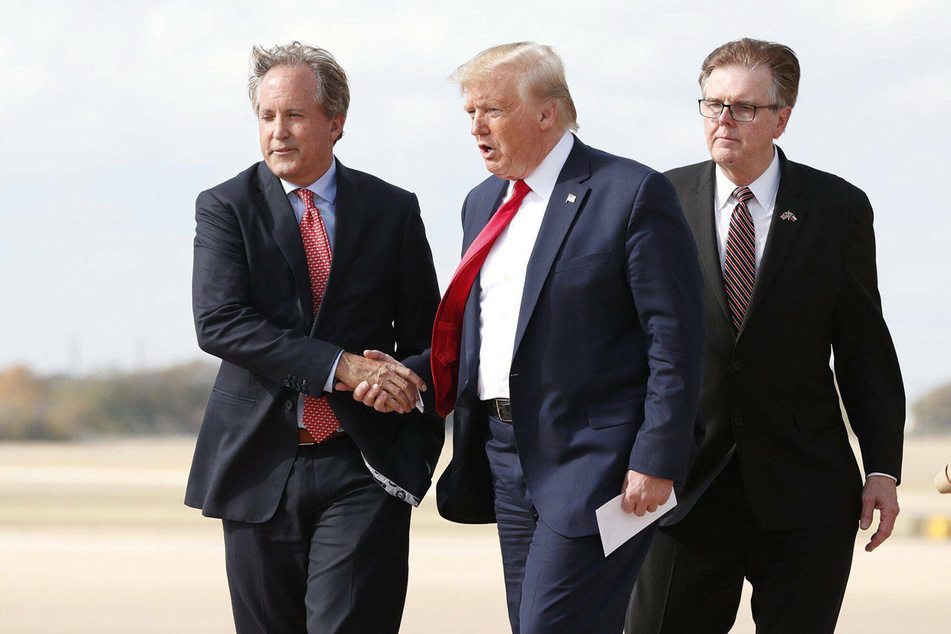 Texas AG Ken Paxton (l.) greeting President Donald Trump at Austin Bergstrom International Airport in November.