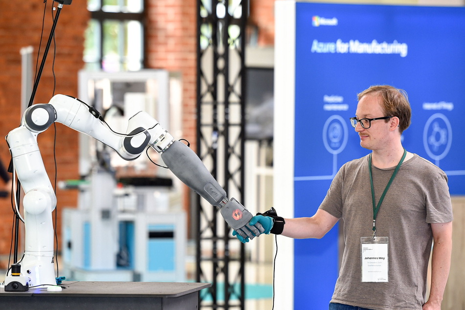 Die Mensch-Maschine-Begegnung: Johannes Mey (37) gibt dem "Hello-Roboter" der TU Dresden die Hand.