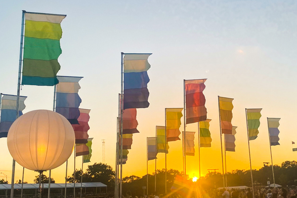 The sun sets upon the flags at Zilker Park during weekend two of Austin City Limits Music Festival.