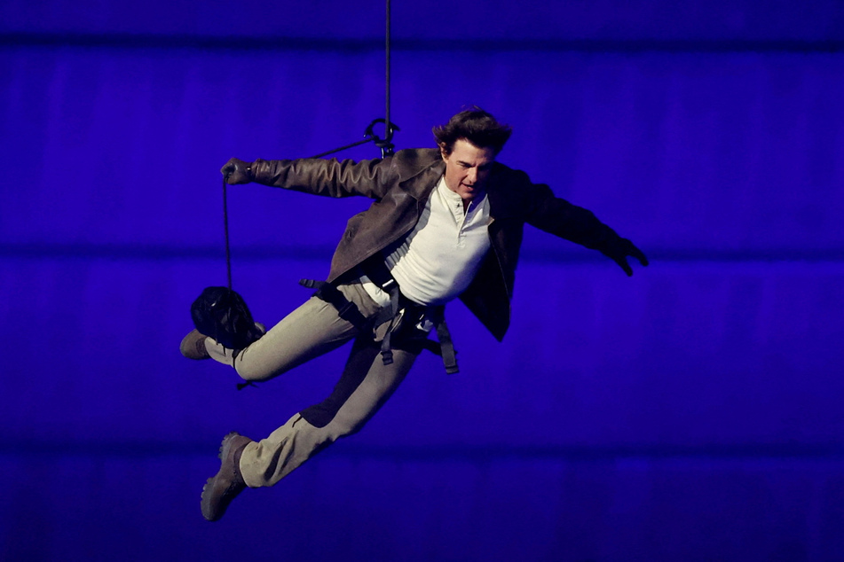 Tom Cruise jumps from the roof of the Stade de France during the Paris Olympics closing ceremony.