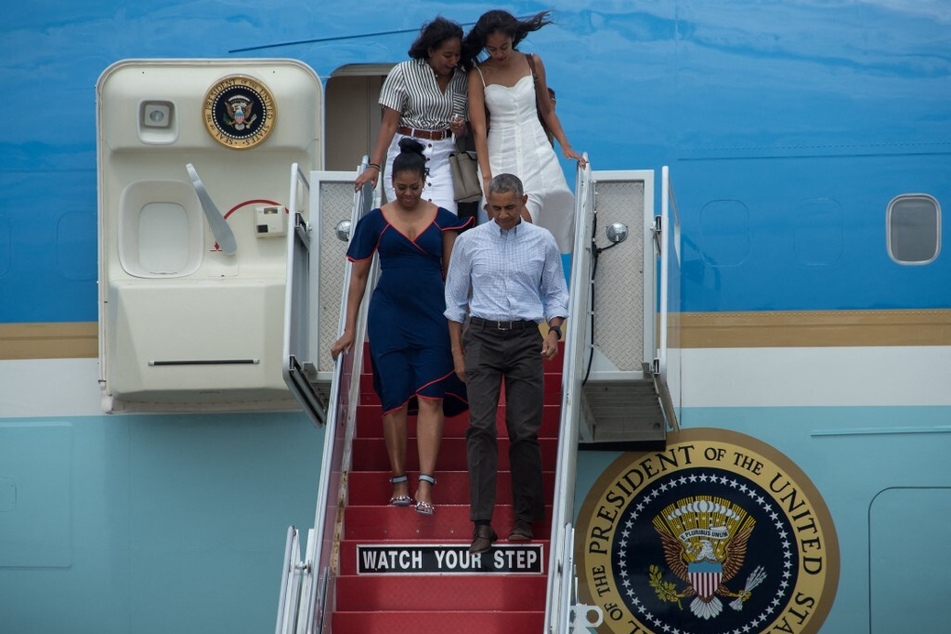 President Barack Obama, First Lady Michelle Obama, and their daughters Malia (upper r.) and Sasha step off Air Force One at Cape Cod Air Force Station in Massachusetts on August 6, 2016.