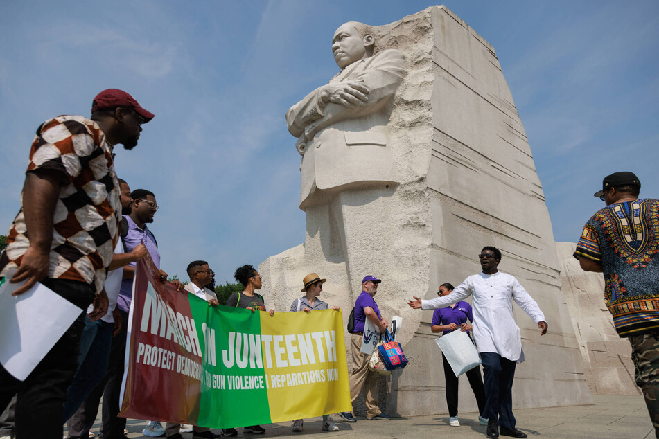 Protesters gather in front of the Martin Luther King Jr. Memorial in Washington DC before beginning their march to the White House.