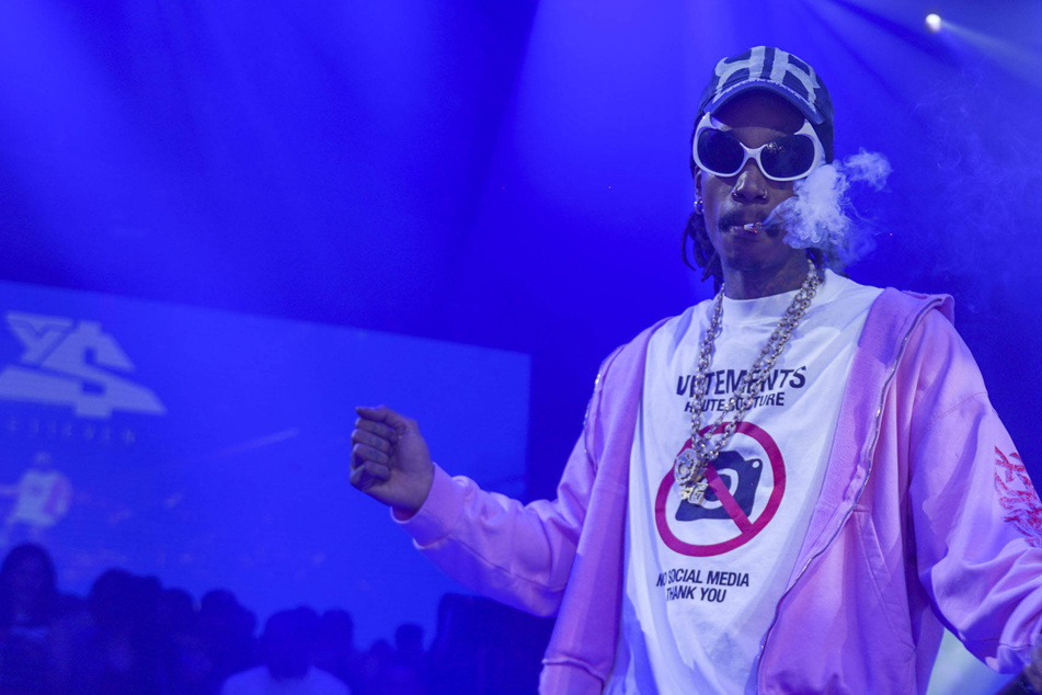 Rapper Wiz Khalifa hit with drug charges after smoking weed on stage in Romania