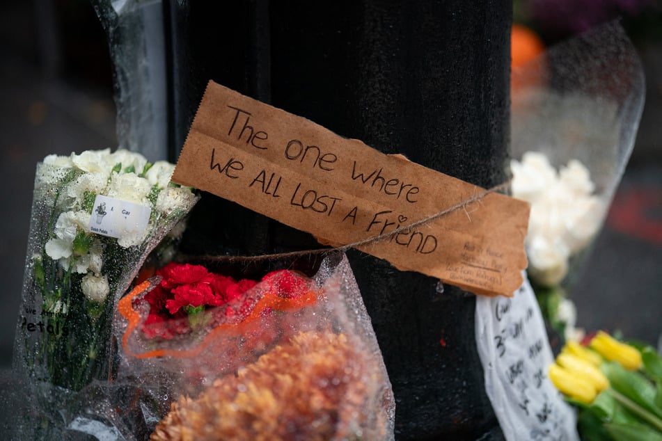Floral tributes are left for actor Matthew Perry outside the apartment building which was used as the exterior shot in the TV show Friends in New York on October 29, 2023.