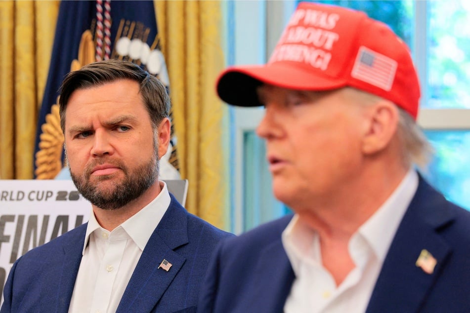 Vice President JD Vance (l.) looks at President Donald Trump (r.) as he talks in the Oval Office in Washington DC on August 22, 2025.