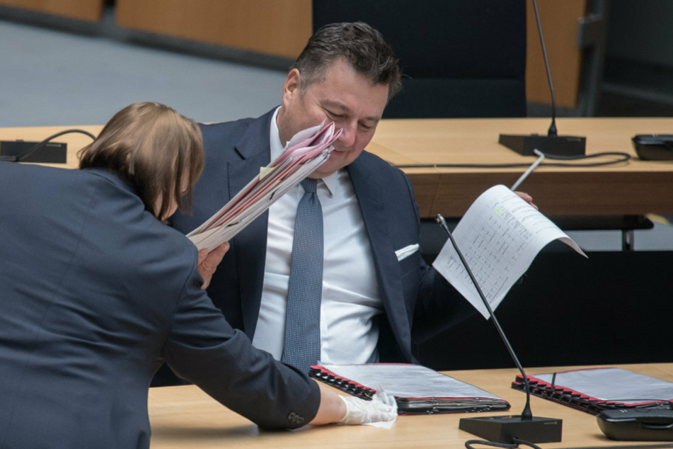 Der Tisch von Andreas Geisel (SPD), Innensenator, wird vor dem Beginn der Plenarsitzung im Berliner Abgeordnetenhaus gereinigt.
