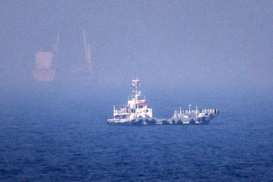 Ships sail near the Strait of Hormuz off the eastern coast of the United Arab Emirates at Khor Fakkan on July 13, 2026.