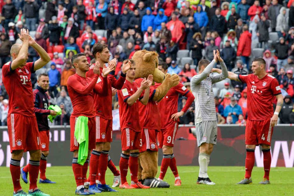 Die Spieler des FC Bayern feiern im Anschluss an den Sieg gegen Hannover vor der Fankurve.