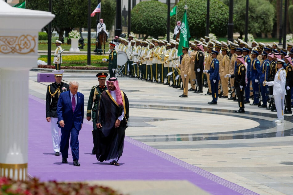 President Donald Trump walks with Saudi Crown Prince Mohammed Bin Salman during a welcoming ceremony in Riyadh, Saudi Arabia, on May 13, 2025.
