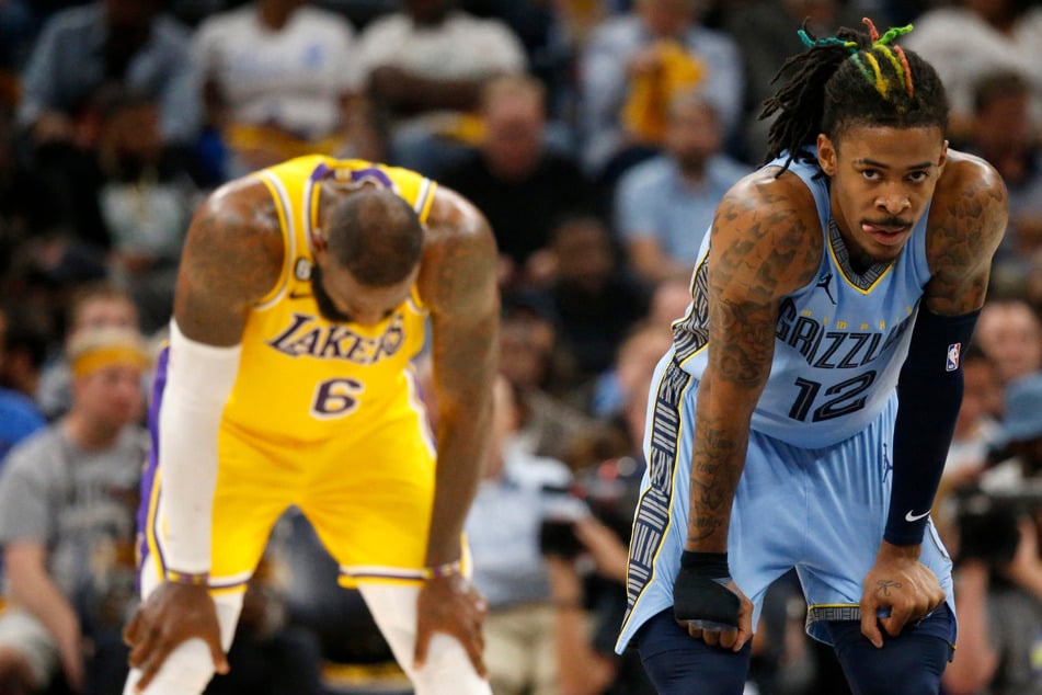 Memphis Grizzlies guard Ja Morant (r.) seen with LeBron James (l.) during game five of the 2023 NBA playoffs.
