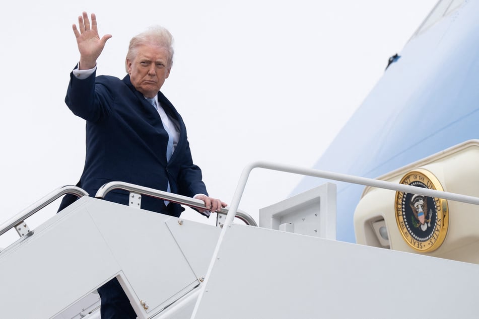 President Donald Trump waves while boarding Air Force One at Joint Base Andrews in Maryland on March 20, 2026.